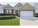 Charming brick home with a well-manicured lawn, a two car garage, and manicured shrubbery at 316 Knawl Rd, Moncks Corner, SC 29461