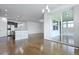 Open-concept living room and kitchen with hardwood floors, island with pendant lights and sliding glass doors at 316 Knawl Rd, Moncks Corner, SC 29461
