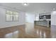 Open-concept living room and kitchen featuring hardwood floors, and an island with a granite countertop at 316 Knawl Rd, Moncks Corner, SC 29461