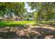 Lush backyard featuring mature trees, a well-maintained lawn, and a view of the home's rear exterior at 327 Mcclain St, Charleston, SC 29407
