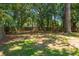Fenced backyard featuring a lush lawn and mature trees providing ample shade and privacy at 327 Mcclain St, Charleston, SC 29407