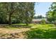 Spacious backyard with mature trees, partial grass coverage and a view of the home's exterior at 327 Mcclain St, Charleston, SC 29407