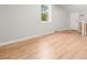 Bright bedroom featuring hardwood floors, a window with outside views, and white trim at 327 Mcclain St, Charleston, SC 29407