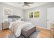 Cozy bedroom features a ceiling fan, two windows for natural light, and neutral decor at 327 Mcclain St, Charleston, SC 29407