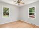 Bright bedroom with two windows features hardwood flooring and a ceiling fan at 327 Mcclain St, Charleston, SC 29407
