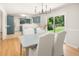 Dining room with a view into a kitchen, modern chandelier, and slider access to the backyard at 327 Mcclain St, Charleston, SC 29407