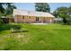 Well-maintained backyard showcasing a lush lawn and the home's brick exterior with a patio at 327 Mcclain St, Charleston, SC 29407