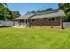 Charming brick home featuring solar panels, a well-maintained lawn, and a welcoming garage at 327 Mcclain St, Charleston, SC 29407