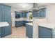 Bright kitchen featuring blue cabinets, stainless steel appliances, and white countertops at 327 Mcclain St, Charleston, SC 29407