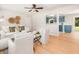 Cozy living room with hardwood floors, white seating, and a view of the kitchen and backyard at 327 Mcclain St, Charleston, SC 29407