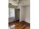 Comfortable bedroom featuring hardwood floors, bright walls, natural light, and access to a closet at 3307 Londonderry Rd, North Charleston, SC 29420