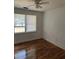 Cozy bedroom with hardwood floors, bright walls, and natural light streaming through the window at 3307 Londonderry Rd, North Charleston, SC 29420