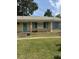 Charming single-story brick home featuring teal shutters, a matching front door, and a well-kept lawn at 3307 Londonderry Rd, North Charleston, SC 29420