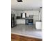Modern kitchen with stainless steel appliances, granite countertops, white cabinets, and tiled flooring at 3307 Londonderry Rd, North Charleston, SC 29420