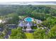 Aerial view of the community pool, clubhouse and lush surrounding greenery at 3525 E Higgins Dr, Mount Pleasant, SC 29466