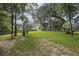 Expansive backyard with lush lawn and mature trees create a serene outdoor space at 3525 E Higgins Dr, Mount Pleasant, SC 29466