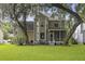 Backyard view showcasing a large, well-maintained lawn, mature trees, and outdoor living spaces at 3525 E Higgins Dr, Mount Pleasant, SC 29466