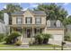 Charming two-story home featuring a welcoming front porch with beautiful landscaping and a two car garage at 3525 E Higgins Dr, Mount Pleasant, SC 29466