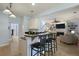 Bright kitchen with bar seating, open to the living room with a fireplace and built-in shelving at 3525 E Higgins Dr, Mount Pleasant, SC 29466