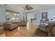 Open-concept living room with hardwood floors, comfortable seating, and natural light at 3525 E Higgins Dr, Mount Pleasant, SC 29466