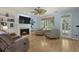 Comfortable living room with a fireplace, a large TV, built-in shelves, and hardwood floors at 3525 E Higgins Dr, Mount Pleasant, SC 29466