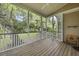 Spacious screened porch with wood floors, offering views of the wooded backyard at 3525 E Higgins Dr, Mount Pleasant, SC 29466