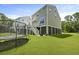 Large backyard with lush lawn, trampoline, and home with stairs to deck at 3705 Sandy Gate Ln, Mount Pleasant, SC 29466