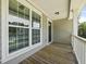 Inviting outdoor balcony with wood decking, white railing and natural light is perfect for relaxing and enjoying nature at 3705 Sandy Gate Ln, Mount Pleasant, SC 29466