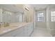 Bright bathroom featuring a double vanity with white cabinets and a large mirror at 3705 Sandy Gate Ln, Mount Pleasant, SC 29466