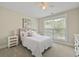 Comfortable bedroom with light pink bed, white wicker nightstands, and a bright window at 3705 Sandy Gate Ln, Mount Pleasant, SC 29466