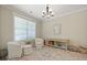 Cozy bedroom with comfortable seating, hardwood floors, ample natural light and a decorative chandelier creating a tranquil retreat at 3705 Sandy Gate Ln, Mount Pleasant, SC 29466