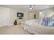 Neutral primary bedroom with bed, dresser, TV, ceiling fan, and open doorway at 3705 Sandy Gate Ln, Mount Pleasant, SC 29466