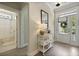 Inviting entryway with hardwood floors, console table and decor with easy access to bathroom and front door at 3705 Sandy Gate Ln, Mount Pleasant, SC 29466