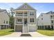 Charming two-story coastal home featuring double balconies, stairs to the entry and well-manicured lawn and landscaping at 3705 Sandy Gate Ln, Mount Pleasant, SC 29466