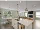 Bright kitchen with island sink, open to dining and living spaces for entertaining at 3705 Sandy Gate Ln, Mount Pleasant, SC 29466