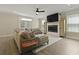 Bright living room with a ceiling fan, a mounted TV above a fireplace, and large windows at 3705 Sandy Gate Ln, Mount Pleasant, SC 29466