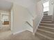 Carpeted stairwell with window, neutral colors, and access to upper and lower floors at 3705 Sandy Gate Ln, Mount Pleasant, SC 29466
