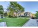 Well-maintained backyard with green lawn, mature trees, and an inviting outdoor living space with a covered deck at 3751 St Ellens Dr, Mount Pleasant, SC 29466