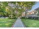 Serene backyard showcasing a paved path, lush lawn, mature trees, and a charming gazebo creating a tranquil outdoor space at 3751 St Ellens Dr, Mount Pleasant, SC 29466