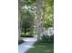 Lush backyard landscaping with a fountain, a black metal fence, and string lights adding to the outdoor charm at 3751 St Ellens Dr, Mount Pleasant, SC 29466