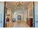 Open doors reveal the foyer with a chandelier and tile floors along with antique furnishings at 3751 St Ellens Dr, Mount Pleasant, SC 29466