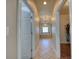 Hallway leading to Primary bathroom with walk-in closet and bathtub with chandelier for elegance at 3751 St Ellens Dr, Mount Pleasant, SC 29466