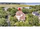 Aerial view of home nestled among mature trees in a neighborhood by the water at 401 Ralston Creek St, Charleston, SC 29492