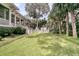 A well-maintained backyard with a decorative water feature, mature trees, and lush greenery at 401 Ralston Creek St, Charleston, SC 29492