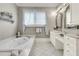 Elegant bathroom with a soaking tub, vanity, and tiled floors for a luxurious feel at 401 Ralston Creek St, Charleston, SC 29492