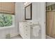 Bathroom featuring a white vanity with marble countertop, framed mirror, and stylish striped wallpaper at 401 Ralston Creek St, Charleston, SC 29492