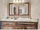 Charming bathroom with granite counters, wood cabinets, and modern fixtures at 401 Ralston Creek St, Charleston, SC 29492