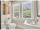 Bright bathroom with white fixtures, vanity, and a large window offering outdoor views at 401 Ralston Creek St, Charleston, SC 29492