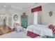 Bright bedroom with wood floors, soft colors, and unique accents creating a cozy space at 401 Ralston Creek St, Charleston, SC 29492