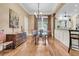Dining room adjacent to the kitchen boasts a glass table and hardwood floors for elegant gatherings at 401 Ralston Creek St, Charleston, SC 29492